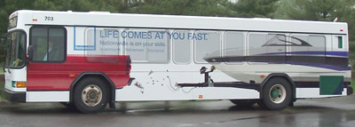 An Amtran bus with Life Comes at your fast bus wrap