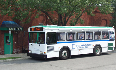 An Amtran bus with Life Comes At you fast bus wrap
